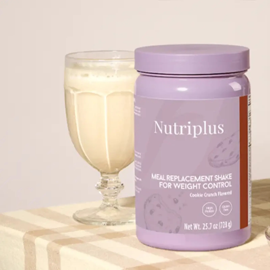 Nutriplus meal replacement shake container with a glass of shake on a light background
